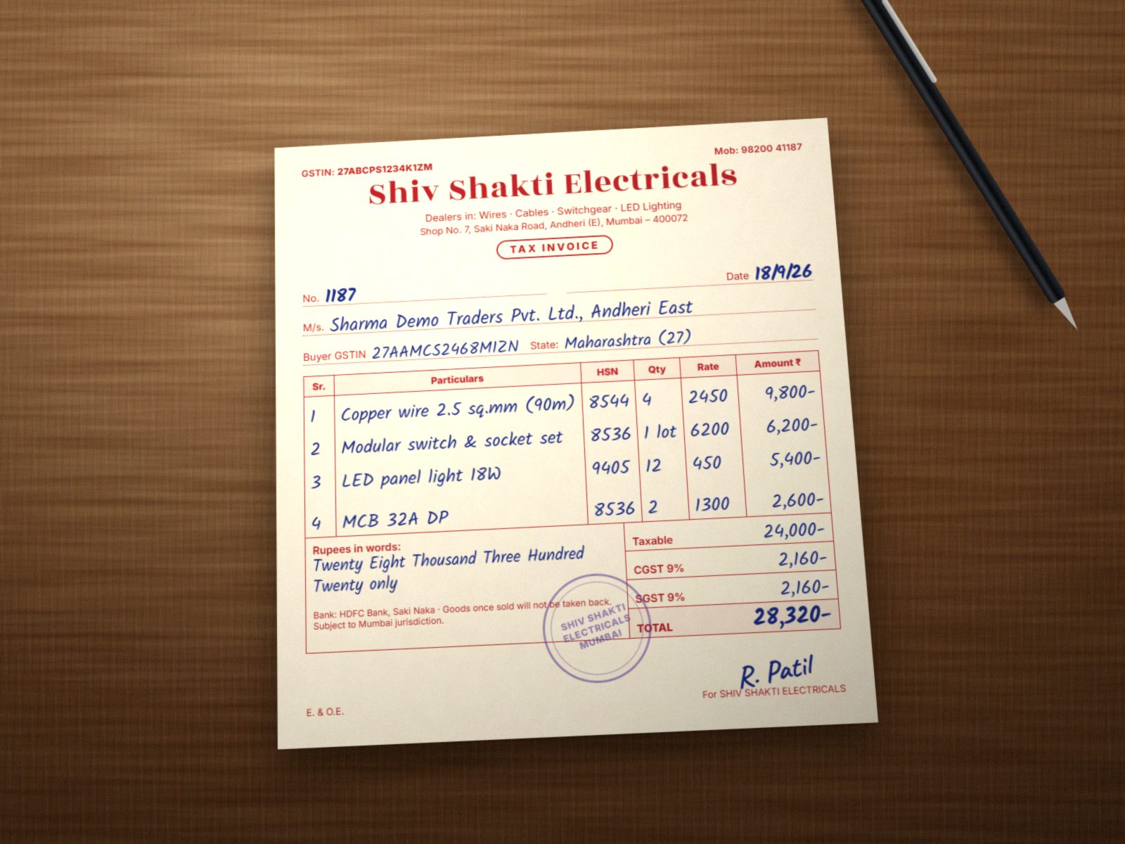 A handwritten tax invoice photographed on a desk